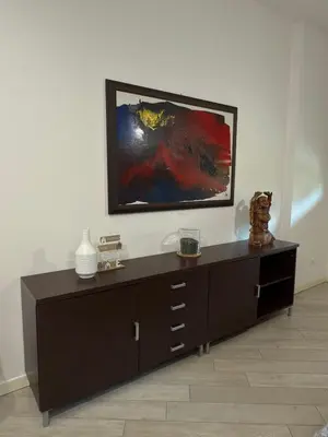 a room with a dresser with a painting on the wall at La Casa di Lella in Rome