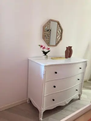 a dresser with a mirror on top of it at La Casa di Lella in Rome