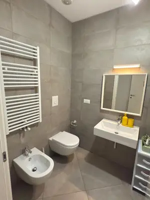 a bathroom with a toilet and a sink and a mirror at La Casa di Lella in Rome