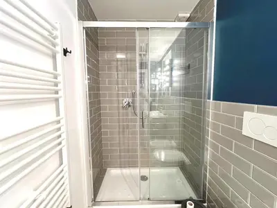 a shower with a glass door in a bathroom at Casa Polveriera at Colosseum in Rome