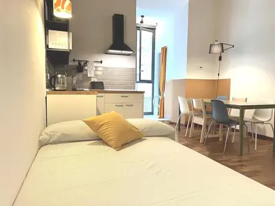 a room with a bed and a kitchen with a table at Casa Polveriera at Colosseum in Rome