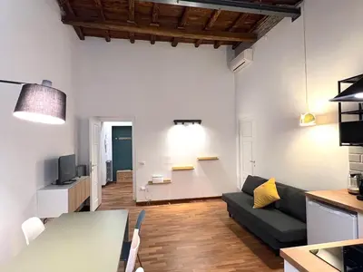 a living room with a couch and a table at Casa Polveriera at Colosseum in Rome
