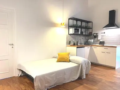 a bedroom with a bed with a yellow pillow on it at Casa Polveriera at Colosseum in Rome