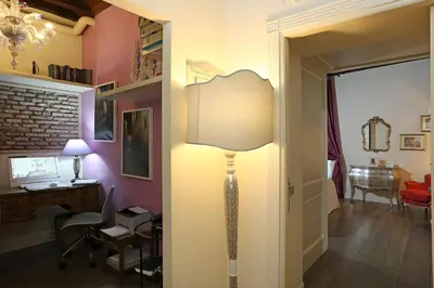 a room with a lamp and a desk in a room at Piazzetta de' Monti Suites in Rome