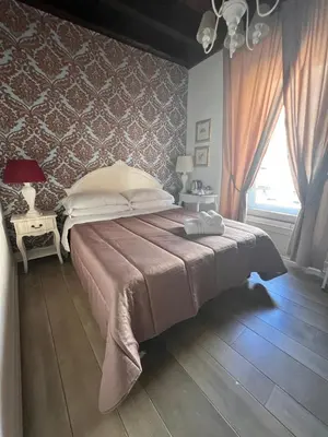 a bedroom with a large bed and a window at Piazzetta de' Monti Suites in Rome