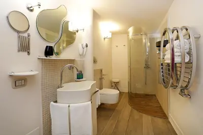 a bathroom with a sink and a shower and a toilet at Piazzetta de' Monti Suites in Rome