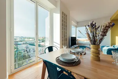 a dining room with a table and a large window at Fifi's Flaminio Panoramic Apartment 120mq in Rome