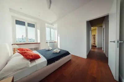 a white bedroom with a bed and a window at Fifi's Flaminio Panoramic Apartment 120mq in Rome