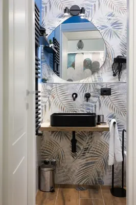 a bathroom with a sink and a mirror at Aida Luxury Apartment in San Giovanni in Rome