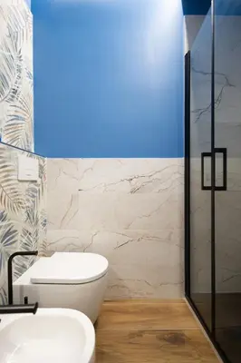 a bathroom with a white toilet and a glass shower at Aida Luxury Apartment in San Giovanni in Rome