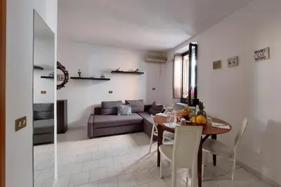 a living room with a table and a couch at Eat Pray Stay Pantheon in Rome