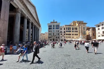 a large group of people walking in a city street at Eat Pray Stay Pantheon in Rome