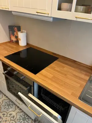 a kitchen with a wooden counter top and an oven at CasaCoco con posto auto e 2 bagni in Rome