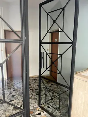a glass door with a glass shelf in a room at CasaCoco con posto auto e 2 bagni in Rome