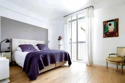 a bedroom with a bed with purple sheets and a window at Appartamento Marissia in Rome