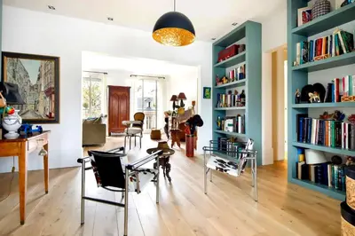 a room with a table and chairs and bookshelves at Appartamento Marissia in Rome