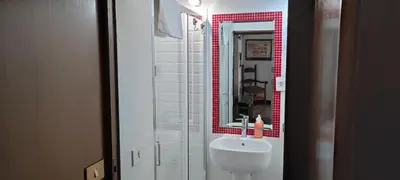 a bathroom with a white sink and a mirror at Colosseum house jp in Rome