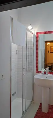 a white bathroom with a shower and a sink at Colosseum house jp in Rome