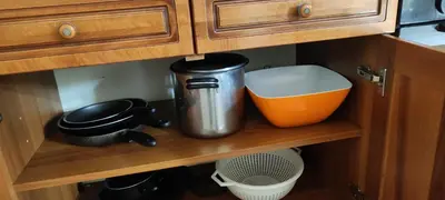a kitchen cabinet with some items on a shelf at Colosseum house jp in Rome