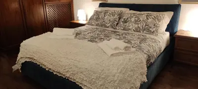 a bedroom with a large bed with two towels on it at Colosseum house jp in Rome