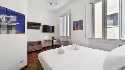 a bedroom with a white bed with two white towels at DolceVite - Fontana Di Trevi in Rome
