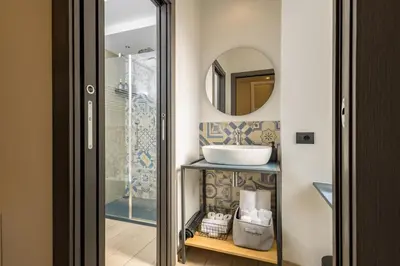 a bathroom with a sink and a mirror at Colosseo Apartment holiday Venus Appartamento al Colosseo a Monti in Rome