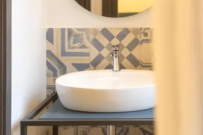 a bathroom with a white sink and a mirror at Colosseo Apartment holiday Venus Appartamento al Colosseo a Monti in Rome