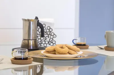 a table with a plate of cookies on aucer at Colosseo Apartment holiday Venus Appartamento al Colosseo a Monti in Rome