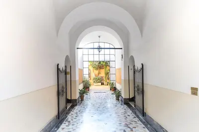 an aisle in a building with a tile floor at Colosseo Apartment holiday Venus Appartamento al Colosseo a Monti in Rome