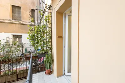 a balcony with plants on the side of a building at Colosseo Apartment holiday Venus Appartamento al Colosseo a Monti in Rome