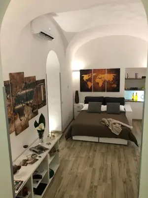 a bedroom with a large bed and a table at Rome's heart in Rome