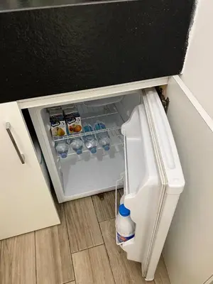 an open refrigerator with drinks inside of it at Rome's heart in Rome