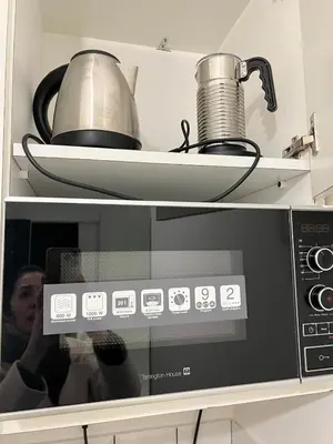 a microwave with a tea kettle on top of it at Rome's heart in Rome