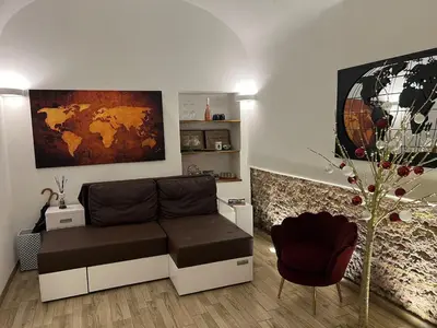 a living room with a couch and a globe on the wall at Rome's heart in Rome