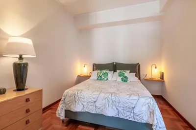 a bedroom with a bed and two lamps and a dresser at Vatican Hills Apartment in Rome