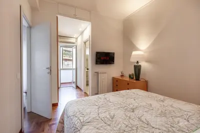 a bedroom with a bed and a dresser and a lamp at Vatican Hills Apartment in Rome