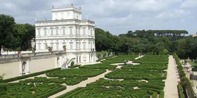 a large white building with a garden in front of it at Vatican Hills Apartment in Rome