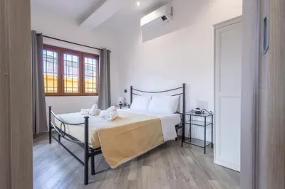 a bedroom with a bed and a table and a window at Il Piccolo Borghetto in Rome