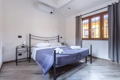 a bedroom with a bed with blue sheets and towels at Il Piccolo Borghetto in Rome