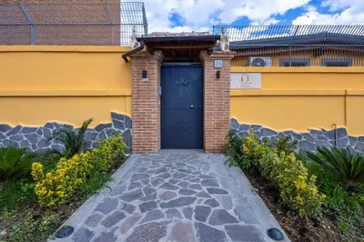 a garage with a blue door on a yellow building at Il Piccolo Borghetto in Rome