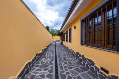 an empty alley between two buildings with windows at Il Piccolo Borghetto in Rome