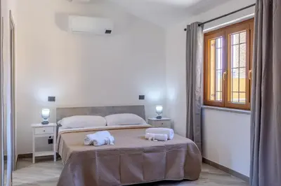 a bedroom with a bed with towels on it at Il Piccolo Borghetto in Rome