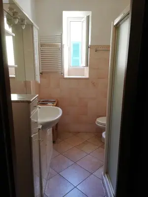a bathroom with a sink and a toilet at Domus Merulana Bed and Breakfast in Rome