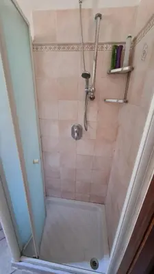a shower in a bathroom with a tile shower at Domus Merulana Bed and Breakfast in Rome