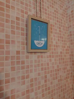 a picture hanging on a tiled wall in a bathroom at Appartamento Delle Grazie in Rome