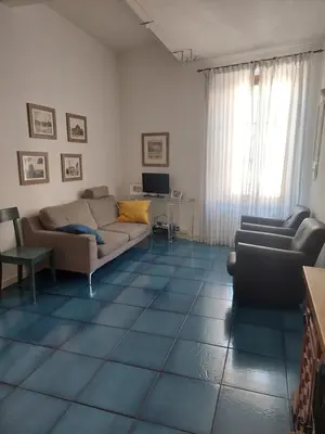 a living room with a couch and a table at Appartamento Delle Grazie in Rome