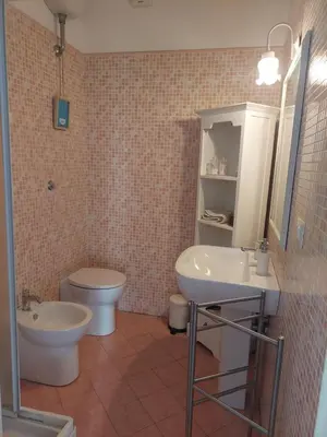 a bathroom with a toilet and a sink at Appartamento Delle Grazie in Rome