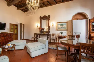 a living room with a table and a dining room at Santa Caterina by the Pantheon - 2BR in Rome