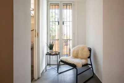 a furry chair sitting in a room with a window at Santa Caterina by the Pantheon - 2BR in Rome