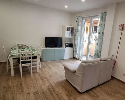a living room with a table and a couch and a television at San Paolo Hideout in Rome